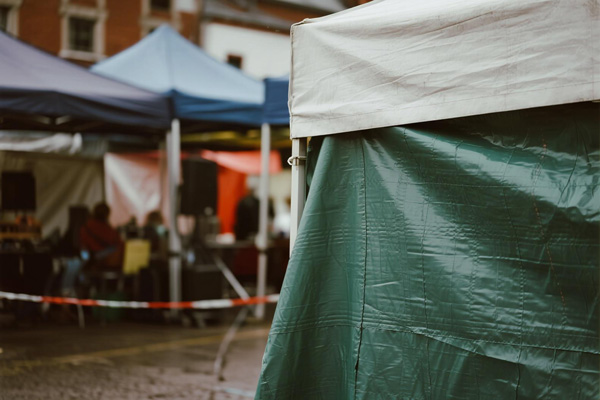 Market stage with performers protected by side covers