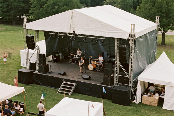 Community event stage with protective side barriers
