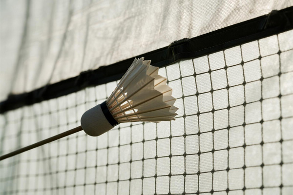Outdoor badminton tournament with protective cover