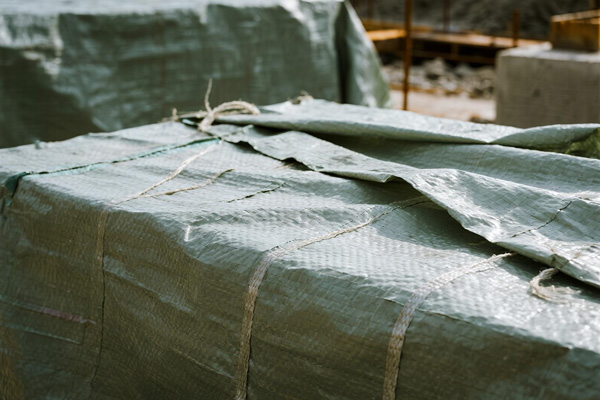 Construction materials and equipment under protective covering