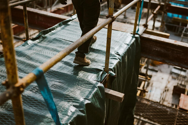 Worker access paths between construction zones covered with moisture-proof cloth