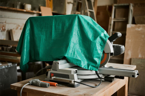 Cutting equipment covered with dust cover in workshop