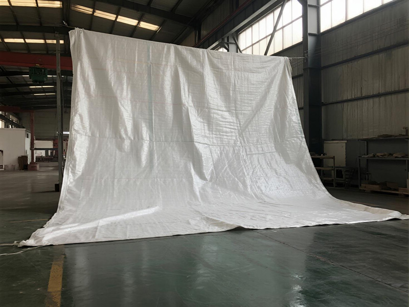 Close-up of emergency tarp material showing reinforced structure and waterproof properties