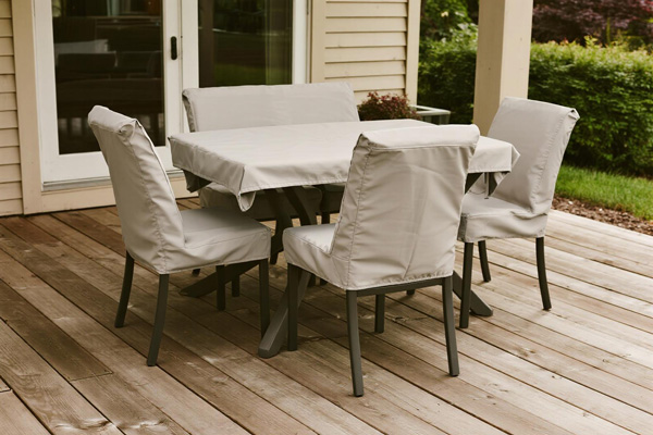 Outdoor patio dining set with protective covers