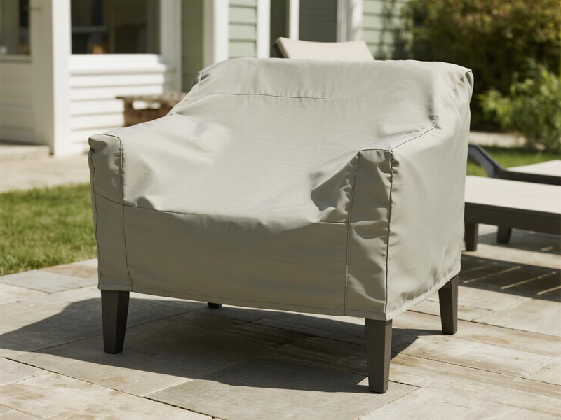Outdoor sofa protected with cover during rainfall