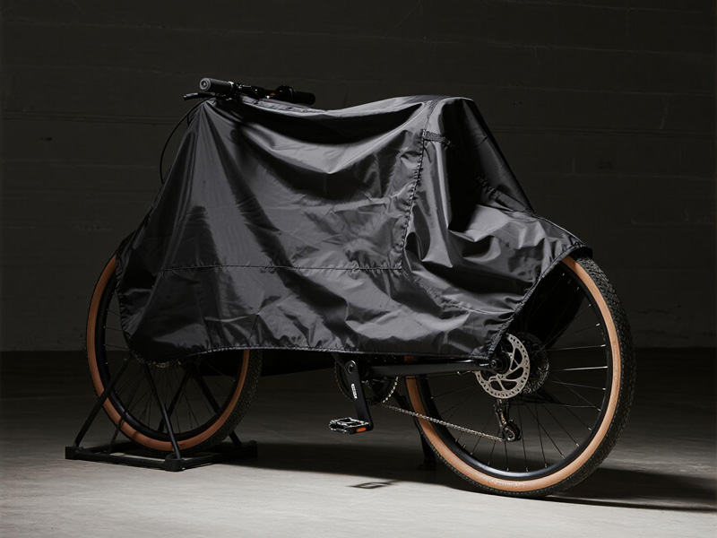 Bicycle protected with Oxford fabric cover in outdoor setting