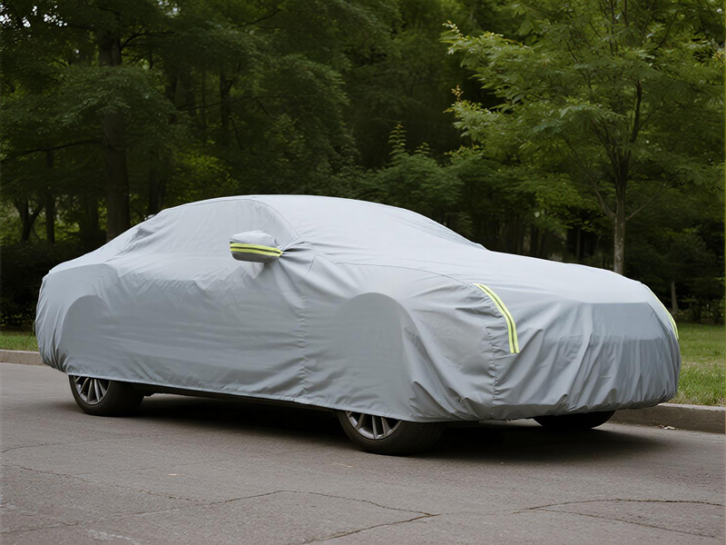 Car protected with Oxford fabric cover in driveway