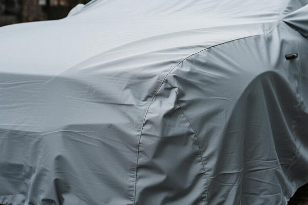 Covered SUV in outdoor parking area