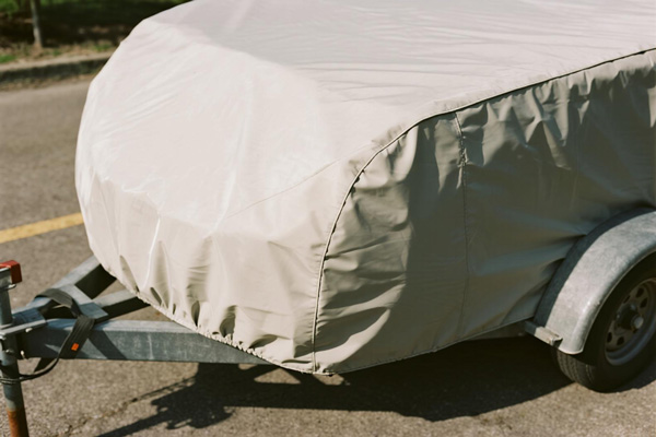 Covered utility trailer in driveway