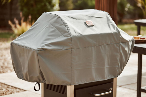 Covered gas grill on residential patio