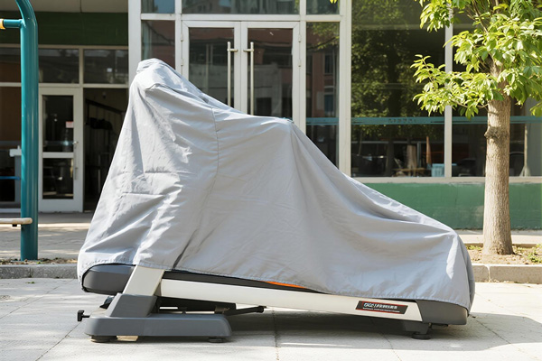 Treadmill covered with fitness equipment cover