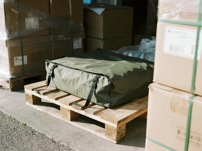 Cargo cover tie-down system with reinforced grommets