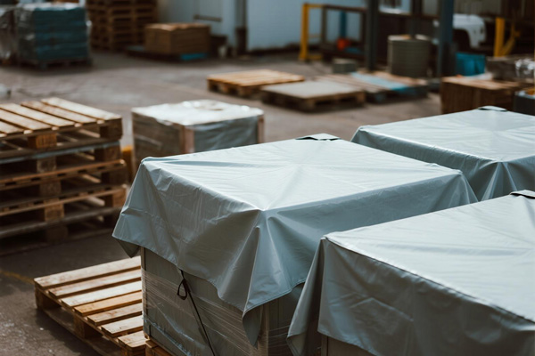 Warehouse yard with covered pallet stacks