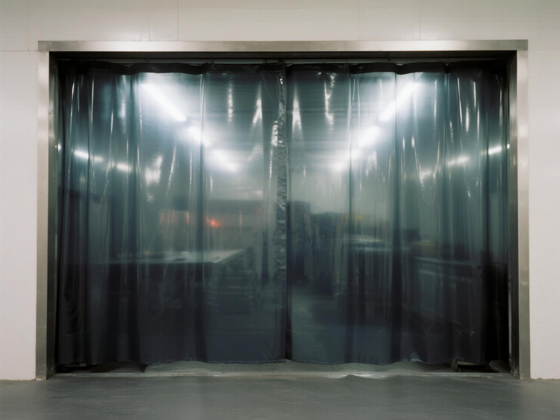 Industrial workshop with partition curtains dividing work areas