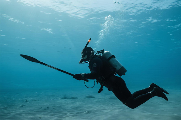 Spearfisher in wetsuit with protective liner