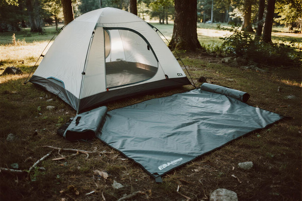 Tarp used as tent footprint under camping tent