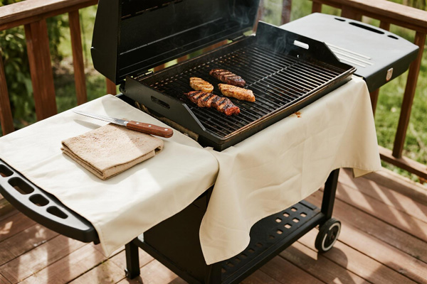 BBQ mat used under charcoal grill on wooden deck