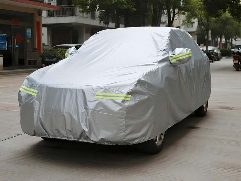 Cleaning demonstration of car cover with hose