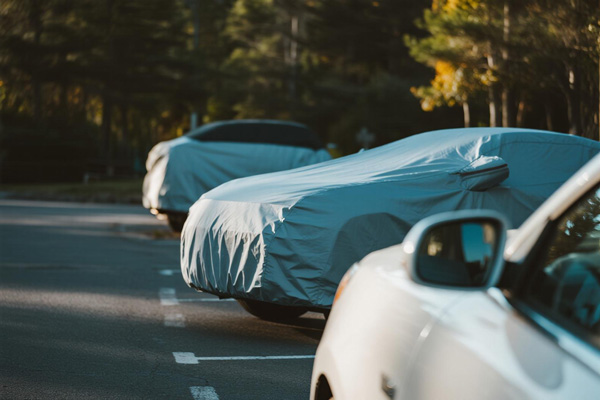 Car cover protecting vehicle in outdoor parking lot