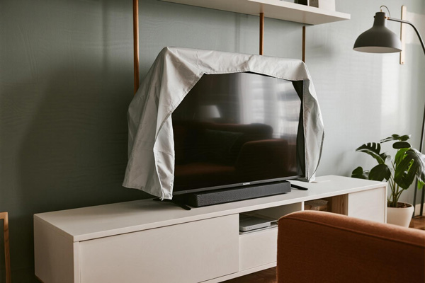 Flat screen TV with fitted dust cover in living room