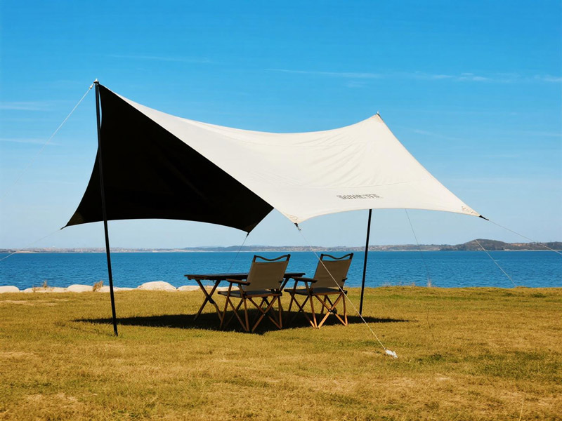 Lightweight Oxford fabric canopy set up at beach with people enjoying shade